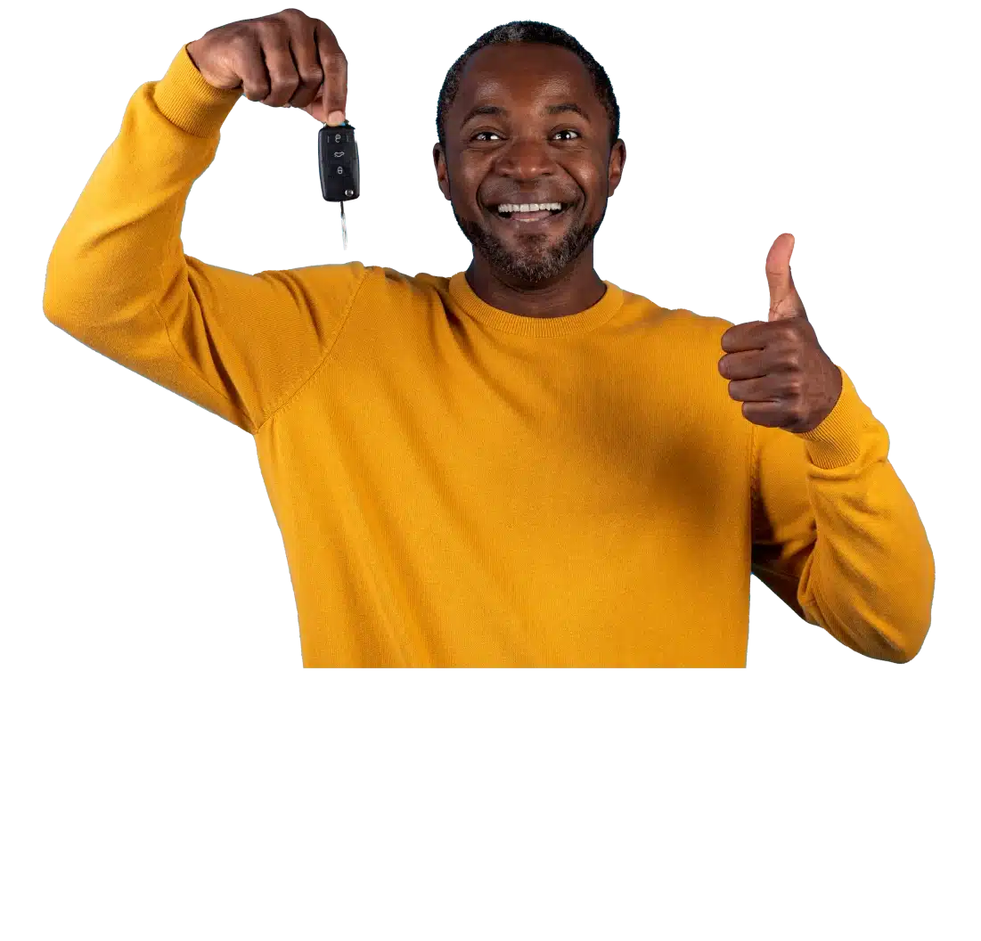 Happy man holding car keys and giving a thumbs up